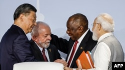 Chinese President Xi Jinping, Brazilian President Luiz Inacio Lula da Silva, South African President Cyril Ramaphosa and Indian Prime Minister Narendra Modi confer during the BRICS Summit in Johannesburg, Aug. 24, 2023.