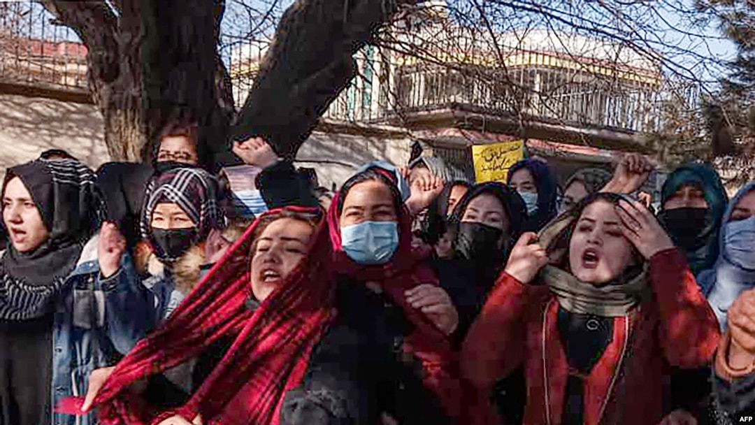 FILE - Afghan women chant slogans to protest the ban on university education for women, in Kabul, Dec. 22, 2022.