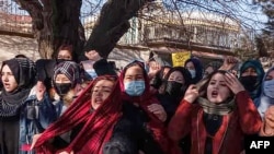 FILE - Afghan women chant slogans to protest the ban on university education for women, in Kabul, Dec. 22, 2022.
