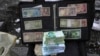 Jasa layanan penukaran uang di Teheran di tengah anjloknya nilai mata uang Iran, Minggu (26/2). 
