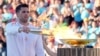 Greek Olympic medalist Ioannis Fountoulis lights the caldron with the Olympic Flame during the Olympic flame handover ceremony at Panathenaic stadium, where the first modern games were held in 1896, in Athens, April 26, 2024. 