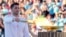 Greek Olympic medalist Ioannis Fountoulis lights the caldron with the Olympic Flame during the Olympic flame handover ceremony at Panathenaic stadium, where the first modern games were held in 1896, in Athens, April 26, 2024. 