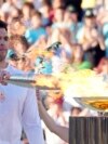 Greek Olympic medalist Ioannis Fountoulis lights the caldron with the Olympic Flame during the Olympic flame handover ceremony at Panathenaic stadium, where the first modern games were held in 1896, in Athens, April 26, 2024. 