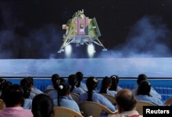 People watch a live broadcast of the Chandrayaan-3 spacecraft landing on the Moon, inside the Gujarat Science City auditorium in Ahmedabad, India, August 23, 2023. (Photo: REUTERS/Amit Dave)