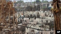 FILE - A view of the destroyed homes and business from the Hawaii wildfires Sept. 1, 2023, in Lahaina, Hawaii. 