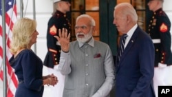 President Joe Biden and first lady Jill Biden welcome India's Prime Minister Narendra Modi to the White House for a private dinner, June 21, 2023, in Washington. 