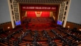 Delegates leave after the opening session of China's National People's Congress (NPC) at the Great Hall of the People in Beijing, March 5, 2023.