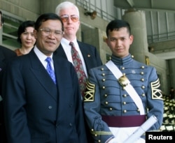 FILE - Cambodia's Prime Minister Hun Sen (L) stands with his son Hun Manet after graduation ceremonies at the United States Military Academy at West Point, May 29. Sen's son, was one of the 934 cadets to graduate.
