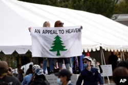 FILE - People carry an "Appeal To Heaven" flag as they gather at Independence Mall to support President Donald Trump during a visit to the National Constitution Center to participate in the ABC News town hall, Sept. 15, 2020, in Philadelphia.