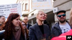 Yulia Navalnaya, center, widow of Alexey Navalny, stands in a queue with other voters at a polling station near the Russian embassy in Berlin, after noon local time, on Sunday, March 17, 2024.