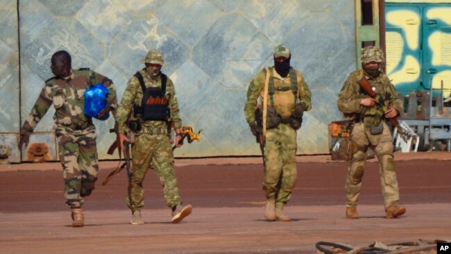 FILE - This undated photo from the French military shows three Russian mercenaries, right, in Mali. Russia's Wagner Group, a private military company, has played a key role in Ukraine fighting and also deployed personnel to the Middle East and Africa.