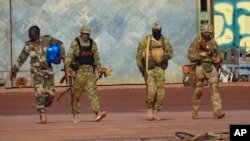 FILE - This undated photo from the French military shows three Russian mercenaries, right, in Mali. Russia's Wagner Group, a now defunct private military company, had played a key role in Russia's invasion of Ukraine, and also deployed personnel to the Middle East and Africa.