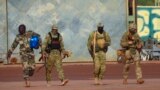 FILE - This undated photo from the French military shows three Russian mercenaries, right, in Mali. Russia's Wagner Group, a private military company, has played a key role in Ukraine fighting and also deployed personnel to the Middle East and Africa.