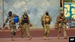 FILE - This undated photo from the French military shows three Russian mercenaries, right, in Mali. (French Army via AP)