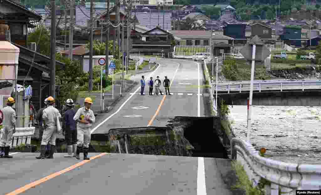 A road near the Saji River collapsed in Tottori, Japan, after Typhoon Lan hit the region, as shown in this photo taken by Kyodo.