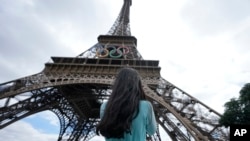 Bangladeshi tourist Rushnia Nur Rayfa stands in front of the Eiffel Tower, ahead of the 2024 Summer Olympics, in Paris, France, July 22, 2024.