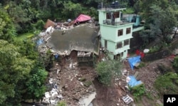 Buildings are seen collapsed following heavy rains in Mandi, Himachal Pradesh, India, Aug. 24, 2023.