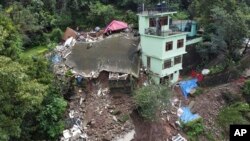 Buildings are seen collapsed following heavy rains in Mandi, Himachal Pradesh, India, Aug. 24, 2023. 