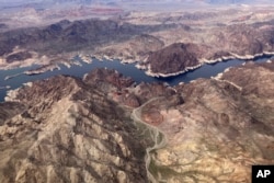 A bathtub ring shows where the water mark on Lake Mead once was along the boarder of Nevada and Arizona, March 6, 2023, near Boulder City, Nev. (AP Photo/John Locher, File)