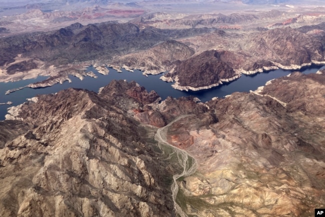 A bathtub ring shows where the water mark on Lake Mead once was along the boarder of Nevada and Arizona, March 6, 2023, near Boulder City, Nev. (AP Photo/John Locher, File)