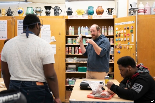 FILE - Art ceramics teacher Jason Sorvari speaks with students at Penn Wood High School in Lansdowne, Pa., Wednesday, May 3, 2023. (AP Photo/Matt Rourke)