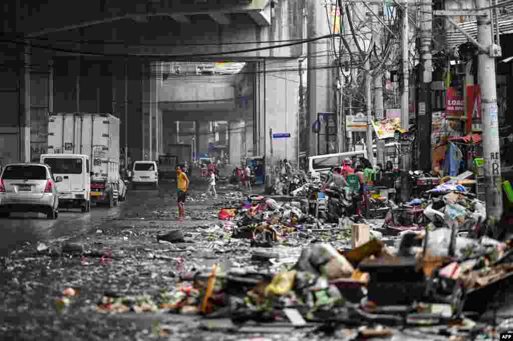 Residents look at their belongings in the aftermath of Typhoon Gaemi in Manila, Philippines, July 25, 2024.