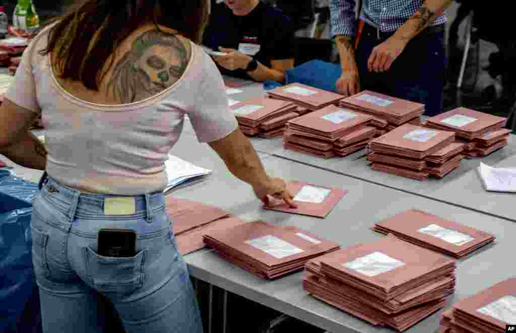 Helpers work on the postal ballots for the European elections in a hall of the fair sound in Frankfurt, Germany, June 9, 2024. 