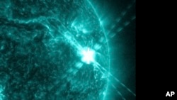 This photo provided by NASA’s Solar Dynamics Observatory captured this image of a solar flare, as seen in the bright flash on the right, on Dec. 14, 2023. 