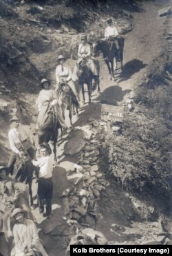 John A. Keirn (lower left wearing hat), wife Clara and family members descend the Grand Canyon's Bright Angel Trail by mule.