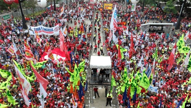 People attend a May Day, or Labor Day, rally in Sao Paulo, Brazil, Monday, May 1, 2023.