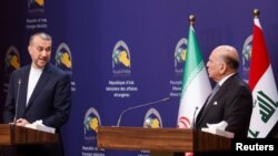 Iranian Foreign Minister Hossein Amir-Abdollahian and Iraqi Foreign Minister Fuad Hussein attend a joint news conference, in Baghdad, Iraq, Feb. 22, 2023. Iran has complained about the presence of Iranian opposition groups at a ceremony in Iraq's autonomous Kurdish region. 