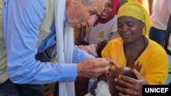 FILE - UNICEF representative Gianfranco Rotigliano gives oral vaccine to a child during the launch of the nationwide typhoid vaccination campaign, May 11, 2023, in Malawi's Balaka district. (UNICEF Malawi)