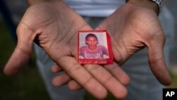 Mohamed, a 19-year-old fleeing political persecution in Mauritania, holds a picture of himself as a child, May 22, 2023, outside the Crossroads Hotel in Newburgh, N.Y.