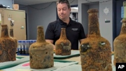 Jason Boroughs discusses artifacts found underneath George Washington's residence in Mount Vernon, Va., on June 17, 2024. Several 18th-century glass bottles containing fruit were unearthed in the mansion cellar of America's first president.(AP Photo/Nathan Ellgren)