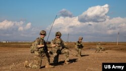 FILE - U.S. soldiers pause during a patrol in Syria, Feb. 3, 2023.