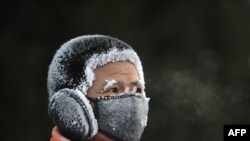 A resident is covered in frost while exercising outdoors during cold weather in Shenyang, in China&#39;s northeast Liaoning province.