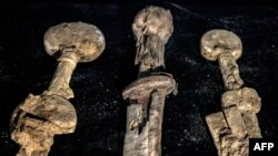 This picture taken on Sept. 6, 2023 shows a view of the pommels of three Roman-era swords preserved in their wooden and leather scabbards, presented at the Jay and Jeanie Schottenstein National campus for the Archeology of Israel in Jerusalem.