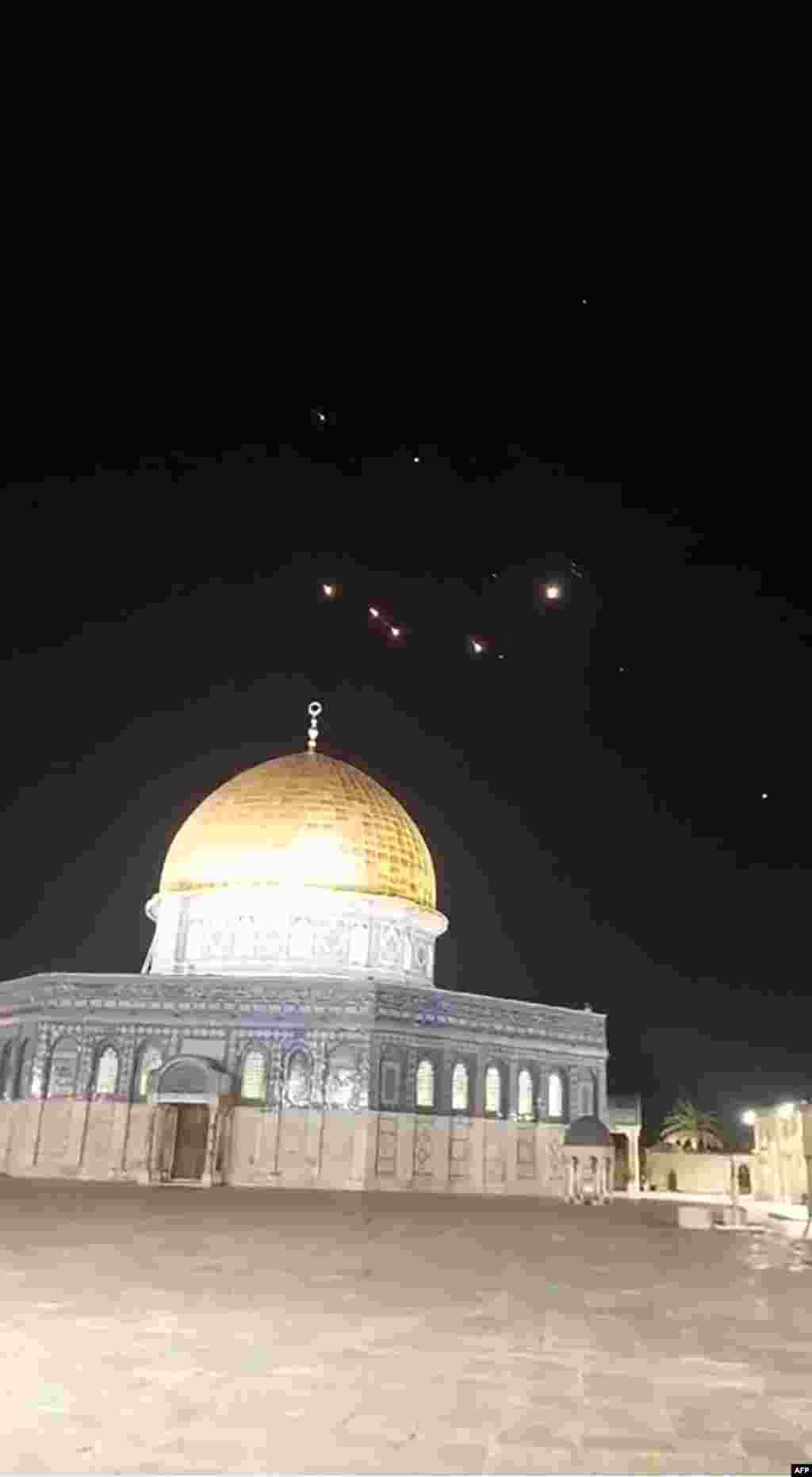 An image-grab from a video taken early on April 14, 2024, shows rocket trails in the sky above the Al-Aqsa Mosque compound in Jerusalem.&nbsp;Iran launched its first-ever direct attack on Israeli territory late on April 13, marking a major escalation of the long-running covert war between the regional foes and sparking fears of a broader conflict breaking out.&nbsp;