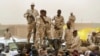 FILE - Sudanese soldiers from the Rapid Support Forces stand on their vehicle during a military-backed rally in Mayo district, Sudan, on June 29, 2019. Experts attribute some of the blame for the current political and social instability in Sudan on climate change.