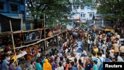 Doctors, paramedics and medical students gather as they attend a protest against what they say was rape and murder of a trainee doctor, inside the premises of R G Kar Medical College and Hospital in Kolkata, India, Aug. 13, 2024. 