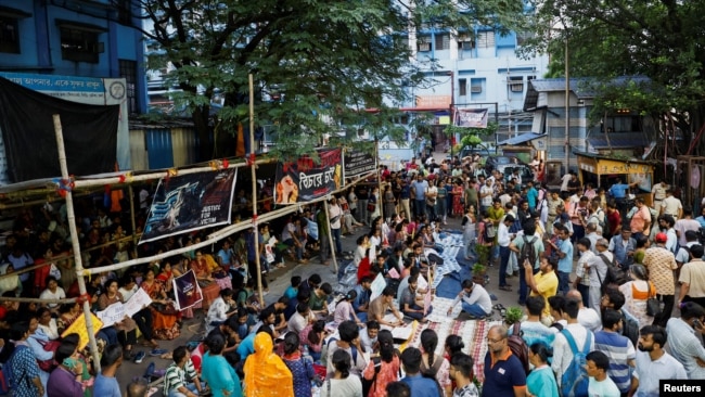 Doctors, paramedics and medical students gather as they attend a protest against what they say was rape and murder of a trainee doctor, inside the premises of R G Kar Medical College and Hospital in Kolkata, India, Aug. 13, 2024. 