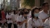 FILE - Students line up for their first day of China's national college entrance examinations, known as the gaokao, in Beijing, June 7, 2023. 