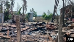 FILE - A destroyed house and burned trees are seen following fighting between Myanmar's military and the Arakan Army ethnic minority armed group in a village in Minbya Township in western Rakhine State, May 21, 2024.