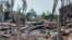 FILE - A destroyed house and burned trees are seen following fighting between Myanmar's military and the Arakan Army ethnic minority armed group in a village in Minbya Township in western Rakhine State, May 21, 2024.
