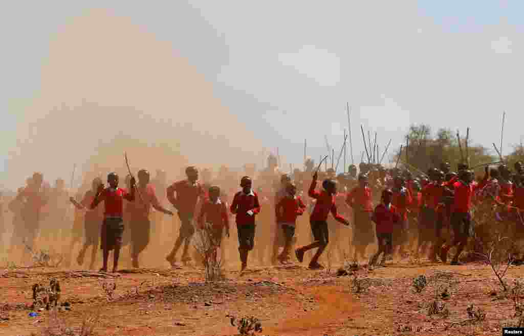School children run to welcome U.S. First Lady Jill Biden at the drought response site at the Lositeti village in Matapato North, Kenya.