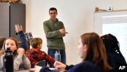 Teacher Donnie Piercey goes over the results of a writing assignment called "Find the Bot" during his class at Stonewall Elementary in Lexington, Ky., Monday, Feb. 6, 2023.