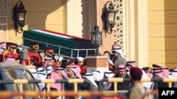 The coffin of Kuwait's late Emir Sheikh Nawaf al-Ahmad Al-Sabah is carried out of the Bilal bin Rabah Mosque in Kuwait City ahead of burial during his funeral,
Dec. 17, 2023. 