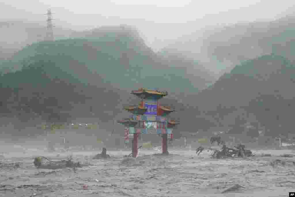 A traditional gate is seen in flood waters in the Miaofengshan area on the outskirts of Beijing, China.
