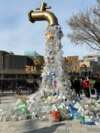 A prop depicting a water tap with cascading plastic bottles is displayed by activists near the Shaw Centre venue of penultimate negotiations for the first-ever global plastics treaty, in Ottawa, Ontario, Canada, April 23, 2024. 