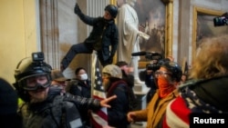 FILE - Pro-Trump protesters storm the U.S. Capitol to contest the certification of the 2020 U.S. presidential election results by the U.S. Congress, at the U.S. Capitol Building in Washington, D.C., U.S. January 6, 2021.